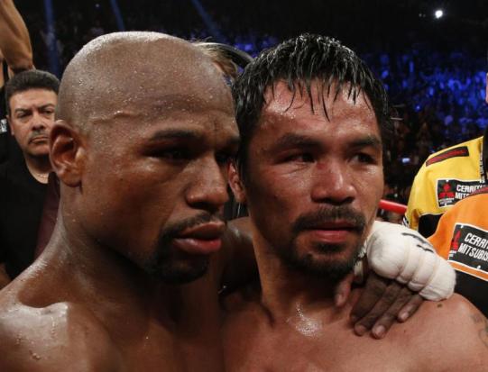 Floyd Mayweather Jr, left, hugs Manny Pacquiao after defeating Pacquiao in their welterweight unification bout at the MGM Grand Garden Arena in Las Vegas, Nevada. (AFP photo)