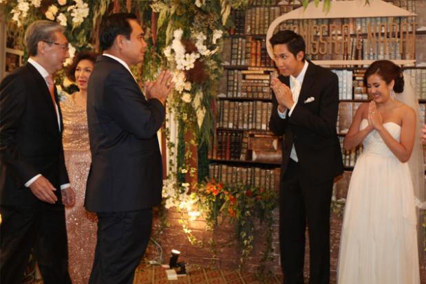 Guest of honour: Prime Minister Prayut Chan-o-cha greets the bride and groom at a wedding at the Mandarin Oriental Hotel in Bangkok. The groom is Napat who is the son of Somkid Jatusripitak, left, an economic adviser to the National Council for Peace and Order.